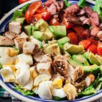 Classic Cobb Salad · Oven roasted turkey, avocado, crumbled blue cheese, mushrooms, carrots, and bacon over mixed...