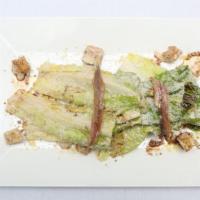 Caesar · romaine, anchovies, croutons, Parmesan cheese, made a la minute.