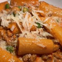 Rigatoni Buttera · Served with hot and sweet sausage, peas, touch of cream.