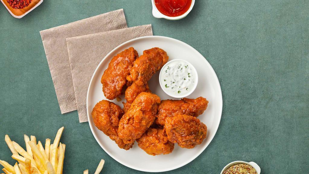 Mango Tango Habanero Wings · Fresh chicken wings breaded, fried until golden brown, and tossed in mango habanero sauce. Served with celery or carrots, and blue cheese or ranch.