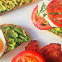 Avocado Toast · Perfectly ripened avocado, laid gracefully on toasted 12 grain bread, topped with tomatoes, ...