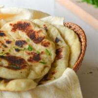 Butter Naan · Unleavened white flour bread freshly baked in tandoor oven glazed with butter.