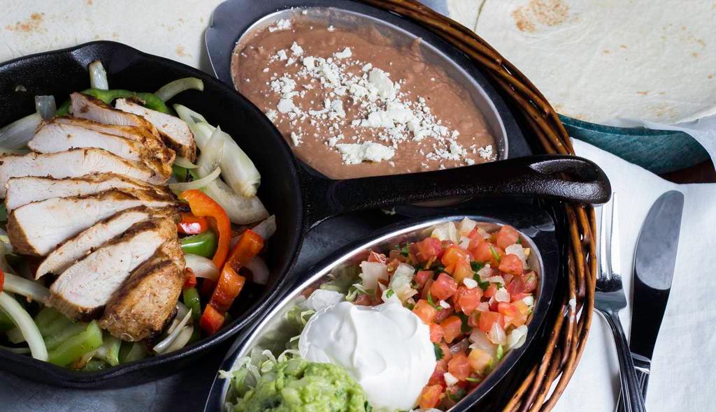 Lunch Fajitas · Grilled beef or chicken fajitas served with three flour tortillas, rice, refried beans and guacamole salad.