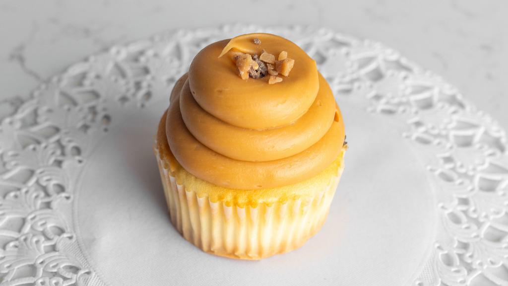 Dulce De Leche · Moist vanilla cake filled with dulce de leche cream, then topped with a caramel buttercream frosting, and a toffee crunch.