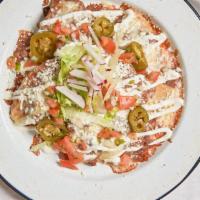 Nachos · Most popular. Crispy tortilla layered with beans and Monterrey cheese, topped with lettuce, ...