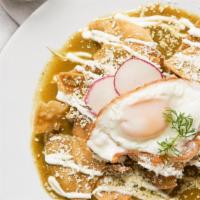 Chilaquiles Verdes · Traditional crispy corn totopos simmered in green tomatillo salsa, onion, Cotija cheese, and...