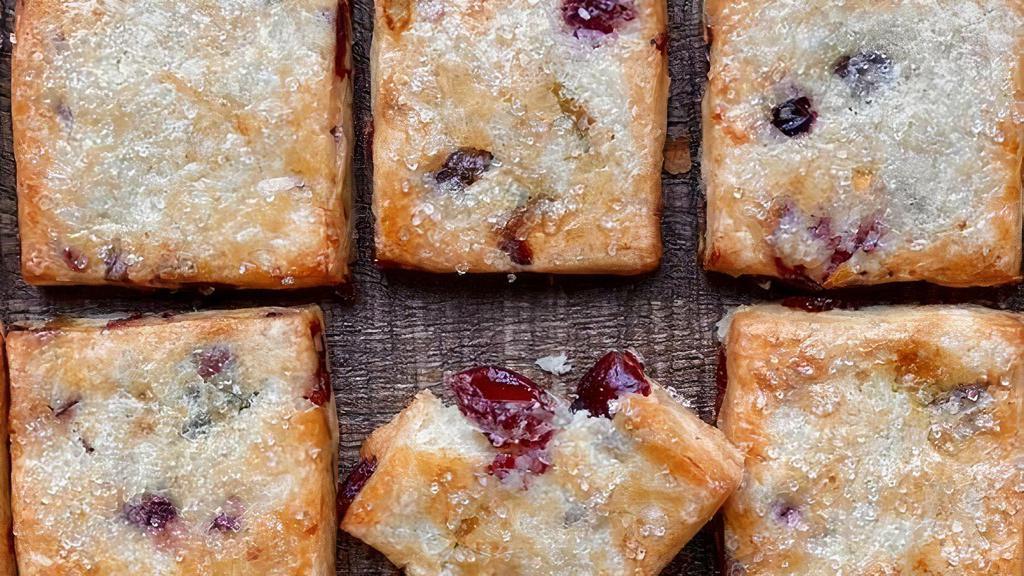 Pistachio Cranberry Shortbread Minis · Delicate shortbread morsels filled with cranberries and pistachios, with a light dusting of sugar