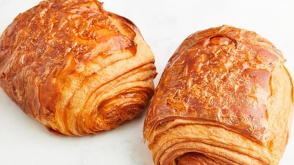 Pain Au Chocolat · Our flaky butter croissant is made with 100% imported French butter and filled with chocolate batons.