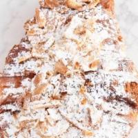 Almond Croissant · Our flaky butter croissant is made with 100% imported French butter and filled with almond c...