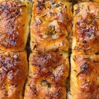 Rosemary Focaccia Pull A Part · Light and airy focaccia topped with olive oil and fresh rosemary.