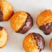 Chocolate Dipped Coconut Macaroons · Chewy and moist coconut macaroons, with a crisp caramelized exterior dipped in chocolate.