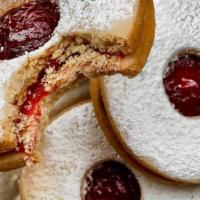 Linzer Cookies · Tender Linzer cookies, dusted in powdered sugar are filled with our bright and tangy raspber...