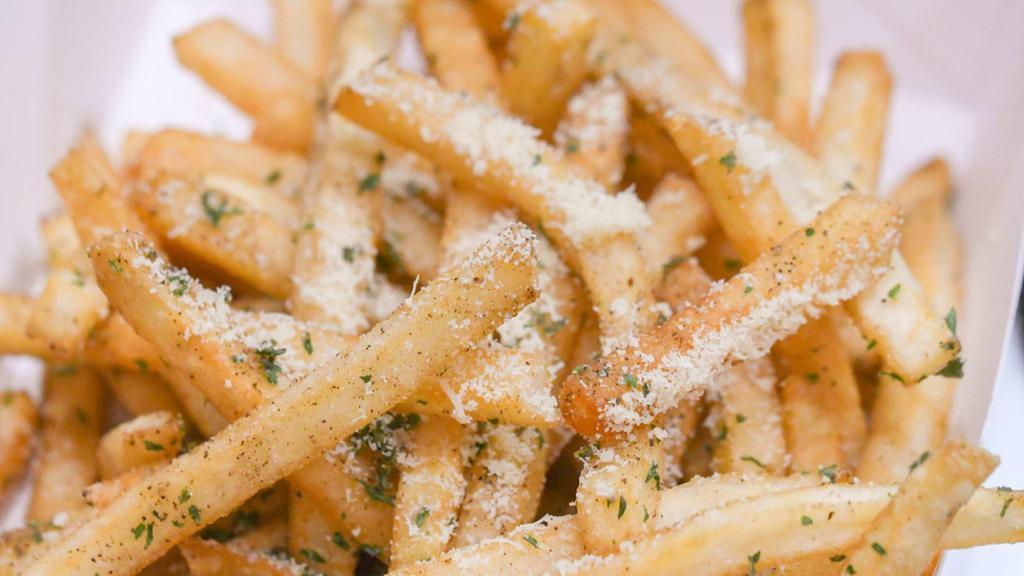 Seasoned Fries · Fresh basket of fries seasoned on top.