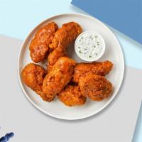 Mango Jango Habanero Wings · Fresh chicken wings fried until golden brown, and tossed in mango habanero sauce. Served wit...