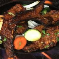 Boti Kabab · Cubed chunks of tender lamb grilled over a slow fire with fresh ginger spices. Served with r...