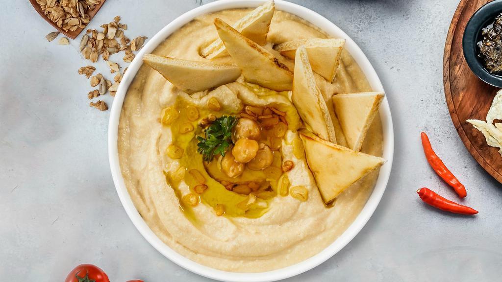 Hummus Platter · Homestyle hummus platter with tahini spiced to perfection with fried pita chips.