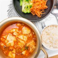 Soondubu Jjigae · Hot stew with soft tofu, kimchi, pork, onions, green scallions + rice.