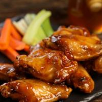 Traditional Hot Honey · 8 hot honey wings (medium heat), served with carrots & celery and a choice of blue cheese, c...