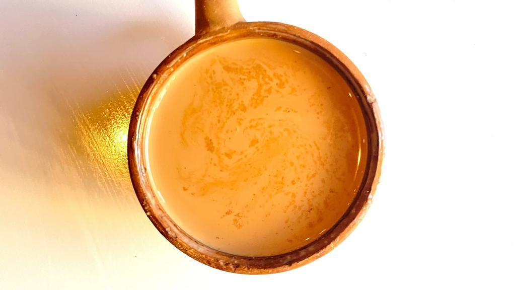 Cardamom Chai · Traditional Masala Chai made with fresh ground spices, black tea, fresh cardamom and boiled milk