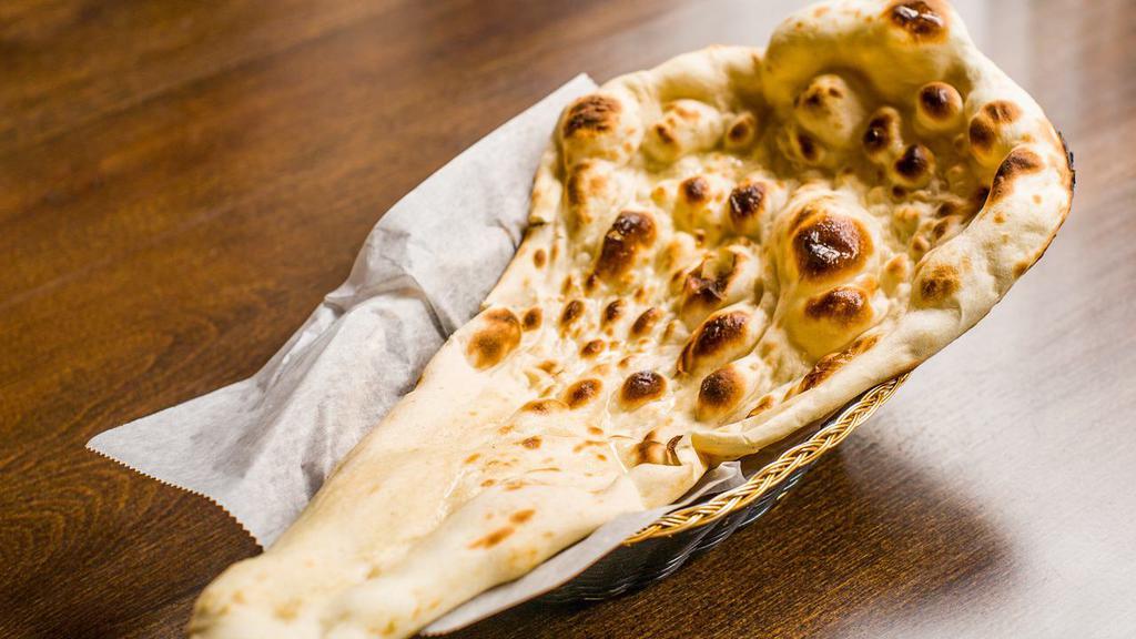 Plain Naan · A leavened flat-bread made w/ flour is baked fresh in tandoor.