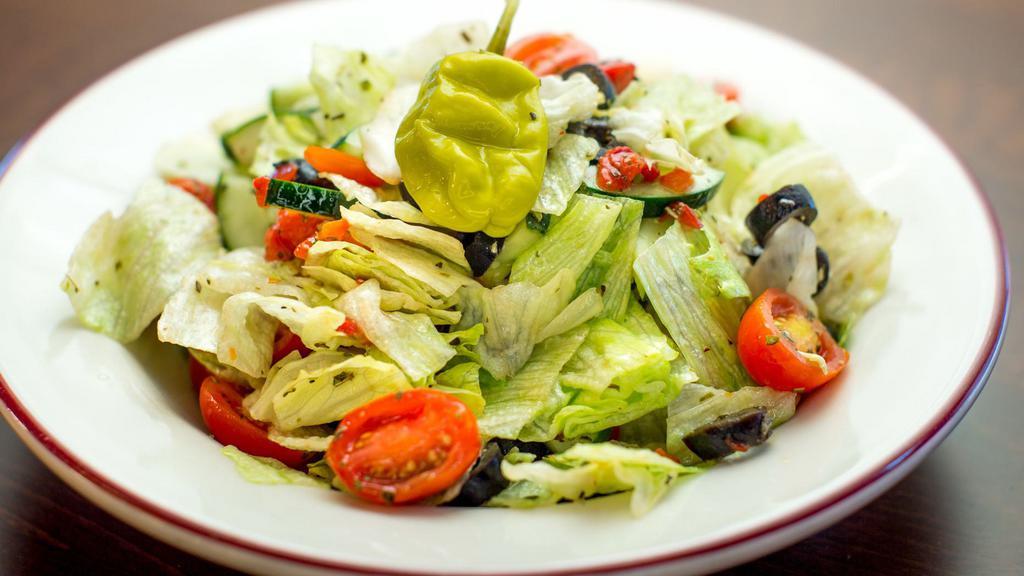Side Salad · Iceberg lettuce, cucumber, tomato, olives, roasted red pepper, pepperoncini, oregano, zesty dressing