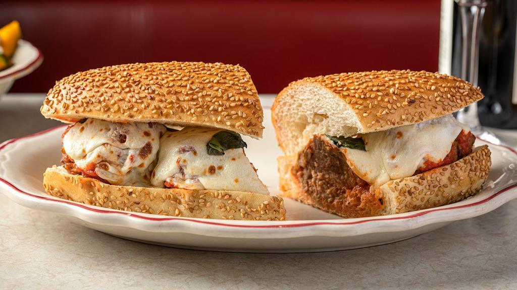 Meatball Parm Hero · Our meatballs are made with pork, beef, and veal making them tender and always pink in the center because of the veal content (but always cooked through to temp). Served on a hero with sesame seeds