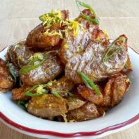 Potatoes · Roasted, smashed, and fried fingerling potatoes tossed in lemon zest and green scallions
