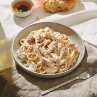 Fettucine Alfredo · Fettucine in rich and creamy Alfredo sauce topped with fresh Parmesan cheese.