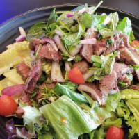 Thai Style Steak Salad · Sliced grilled steak tossed in thai dressing with mint, basil, red onions, chinese parsley, ...