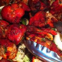 Tandoori Chicken · Chicken cooked with ginger, garlic, hung yogurt and spices.