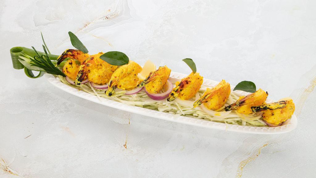 Tandoori Shrimp · Tandoor grilled shrimp marinated with cilantro, lemon juice, herbs & spices.