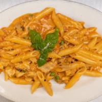 Penne Alla Vodka · Pink cream sauce with peas.