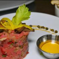 Steak Tartare · Fresh ground beef, chopped pickles, shallots, egg yolk, capers, and pickled mushrooms.