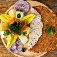 Lahmacun · Meat pie. Anatolia's version of ancient Turkish meat pie with ground lamb, topped with parsl...