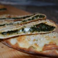 Spinach Pide · Thin crust topped with spinach and mozzarella cheese.