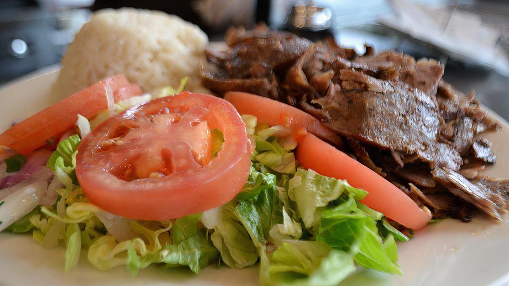 Gyro · Layers of marinated ground meat, wrapped around the large vertical split and grilled in front of an ingenious herd of charcoal fire. Served with salad and side.