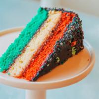 Rainbow Cookie Cake · Slice. Made with almond cake layers, a raspberry filling, and is covered in a rich chocolate...