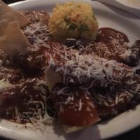 Steak Tampiquena · Grilled thin cut sirloin topped with cheese enchiladas and mole sauce