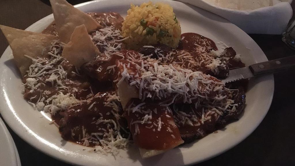 Steak Tampiquena · Grilled thin cut sirloin topped with cheese enchiladas and mole sauce