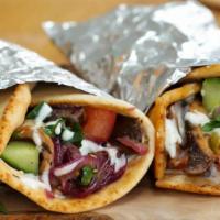 Gyro Wrap · Option of beef, chicken or mix with lettuce, tomato, onions, white sauce, rolled in pita bre...