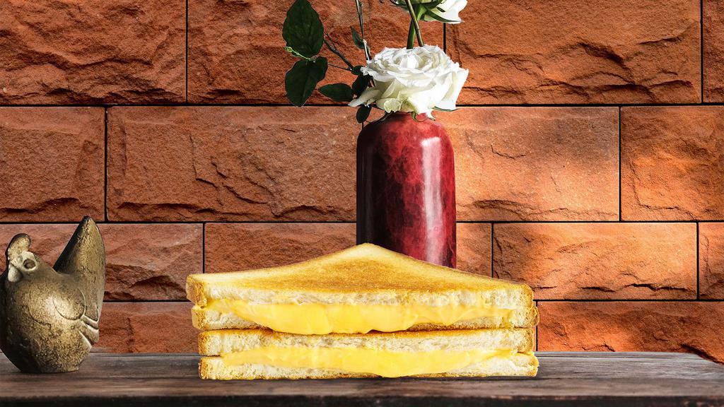 Ny'S Best Grilled Cheese · Melted American cheese between two slices of buttery grilled bread.