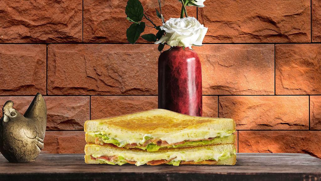 Fancy Grilled Cheese · Melted cheddar and mozzarella cheese with caramelized onions, tomato, and ripe avocado, between two slices of buttery grilled bread.