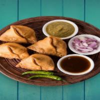 Traditional Samosas (2Pcs) · baked pastry with a savory filling like spiced potatoes, onions,  & peas