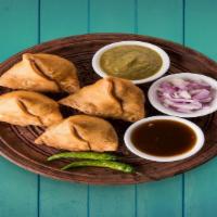 Traditional Samosas (2Pcs) · baked pastry with a savory filling like spiced potatoes, onions,  & peas
