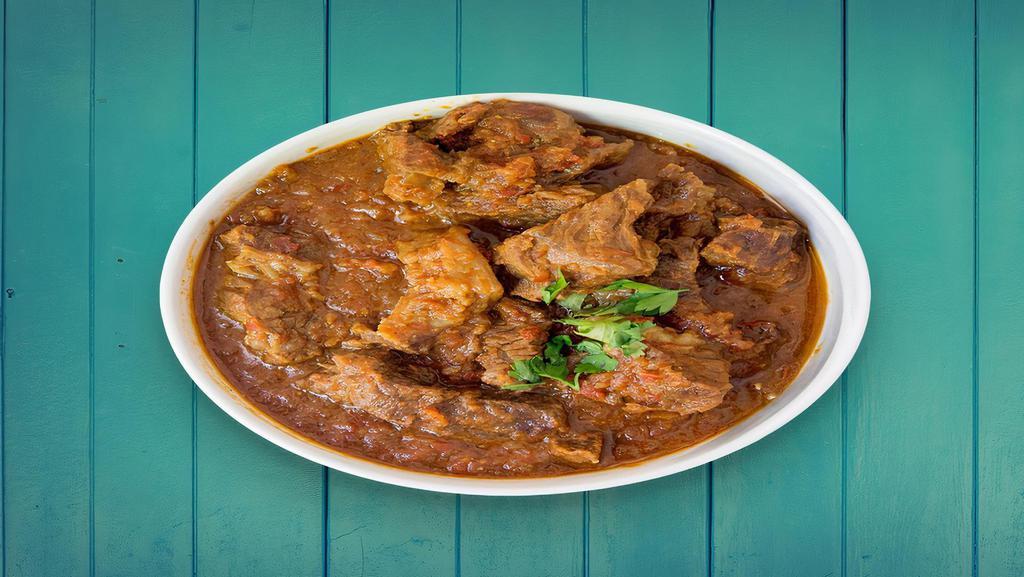 Lamb Rogenjosh · finely cut pieces of lamb in a gravy made of yogurt, garlic, ginger, onions and house blend spices