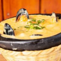 Cazuela De Mariscos. · Seafood casserole (with three side orders / con tres acompañantes).