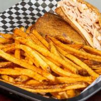 Oven Roasted Turkey Rachel · Thick slices of slow-roasted turkey breast topped with coleslaw, aged Swiss cheese, and thou...