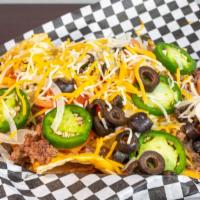 Nachos Supreme · A heaping basket of tortilla chips topped with seasoned meat, nacho cheese, tomatoes, onions...