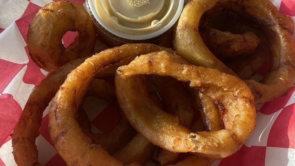 Black & Tan Onion Rings · Premium beer-battered onion rings deep fried and served with a side of house-made chipotle dipping sauce.