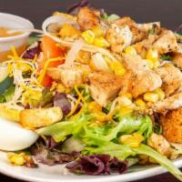 Cobb Salad · Grilled chicken on a bed of mixed greens; topped with bacon, hard-boiled egg, corn, cucumber...